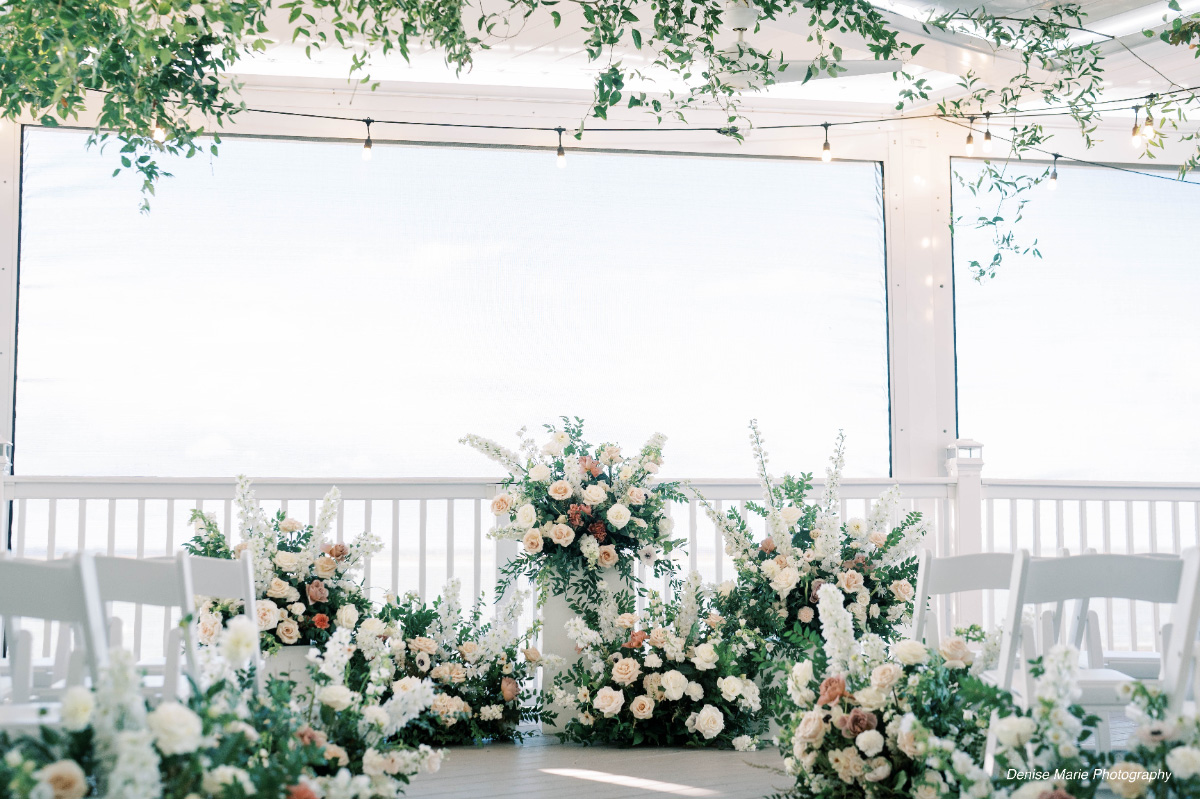 Wedding-ceremony-flowers-with-white-chairs-WEDDING-&-EVENTS-Ceremonies-Avalon-Yacht-Club